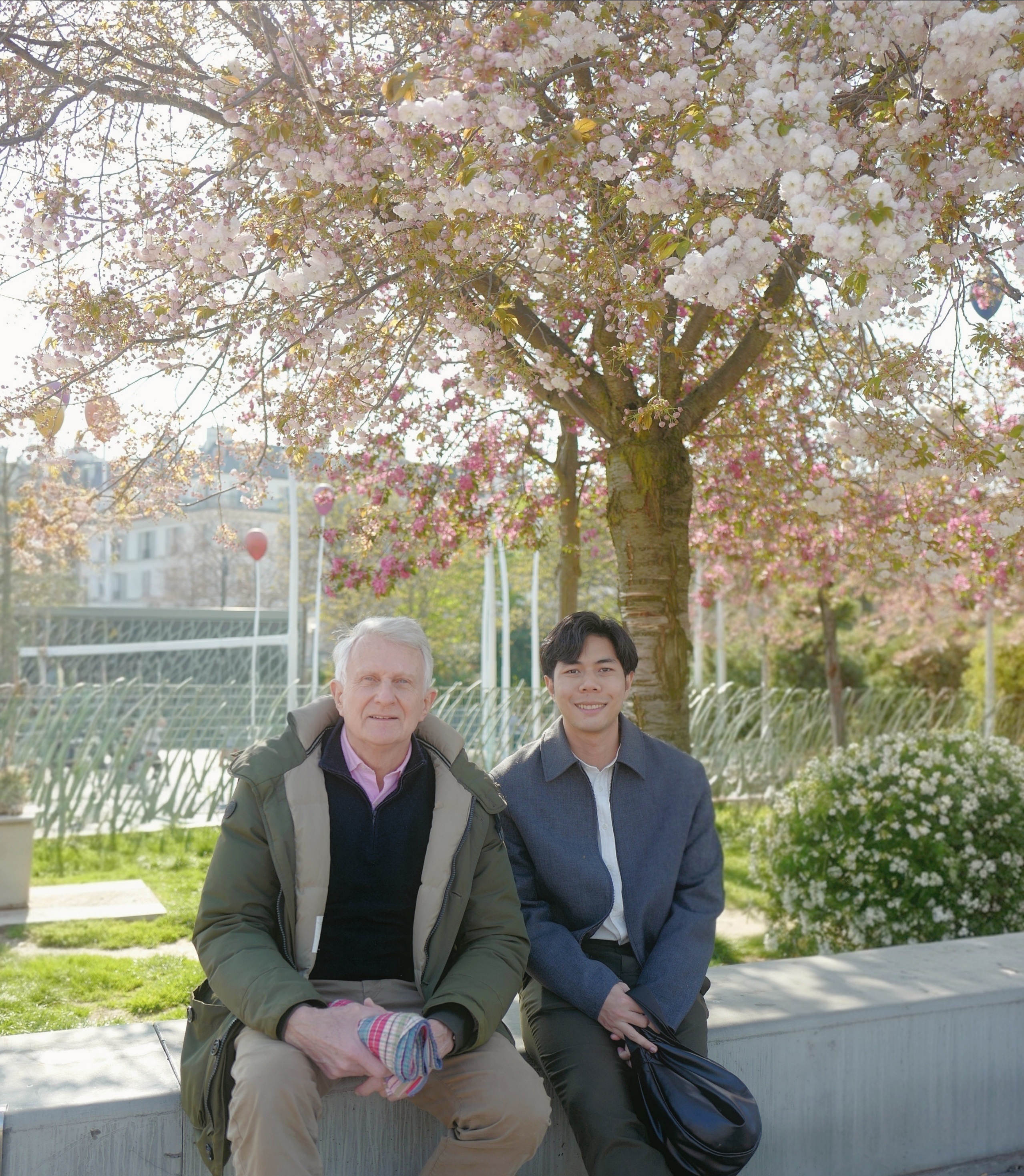 Jacques and Marc under cherry blossoms in Paris